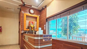 A reception desk with a sign indicating the Banquet Hall is on the 3rd floor. - Hotel Meera Regency (Chiplun)