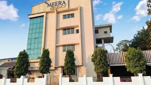 A modern building with the sign "MEERA REGENCY" on the facade. - Hotel Meera Regency (Chiplun)