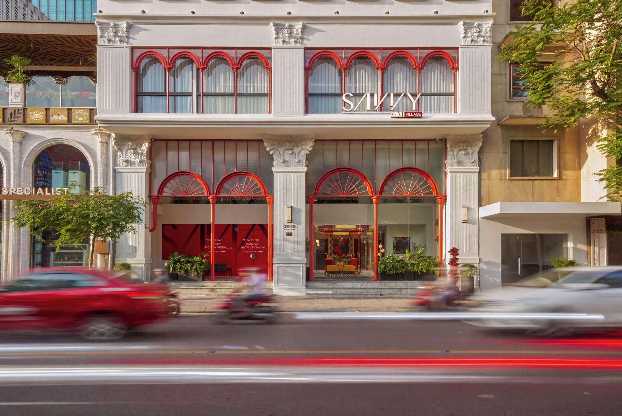 A building with a prominent sign reading 'SAVVY' and a storefront with a red awning.