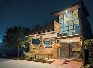 A modern two-story building with large windows and a wooden facade. - Alwar Villa - Gagal Home (Alwar)
