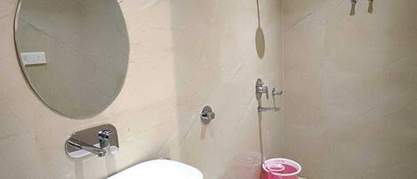 A bathroom with a sink, toilet, and shower.