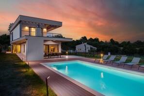 A modern two-story house with a swimming pool, outdoor seating, and a sunset sky. - Private Villa near Svetvincenat with possibility of heated pool (Štokovci)