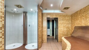 A modern bathroom with a curved bench, a shower area, and a tiled floor.