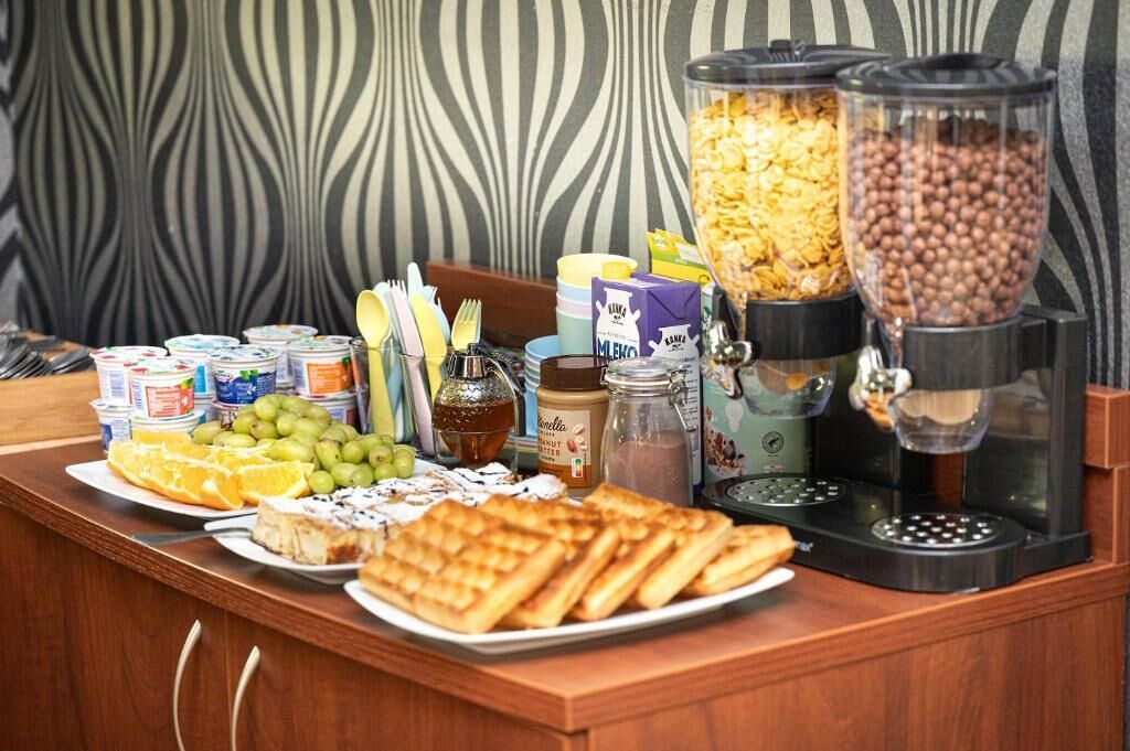 A buffet setup with various food items and condiments.