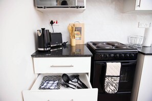 Fridge, microwave, oven, stovetop - At Twelve premium guest apartment (Gaborone)