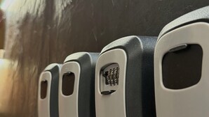 A row of four keycard holders on a dark surface. - HS Altet Suites - Alicante Airport (Elche)