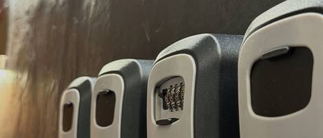 A row of four keycard holders on a dark surface.