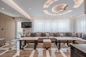 Ein modernes Wohnzimmer mit einem Ecksofa, einem Couchtisch und einem Musterfußboden.