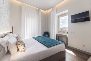 Superior Quadruple Room, City View | In-room safe, desk, laptop workspace, blackout drapes