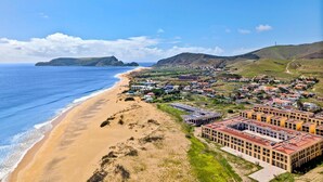 A coastal town with a beach, buildings, and hills in the background. - Holiday Home 'Casa Do Cabeco' with Sea View and Wi-Fi (Cabeco de Ponta)
