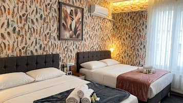Premium bedding, memory-foam beds, desk, laptop workspace