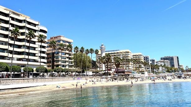 A beachfront hotel with multiple balconies, a beach, and a clear sky. - Marbella Center – 350m from the Beach (MARBELLA)