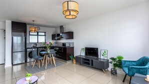 A modern kitchen with a built-in oven, microwave, and a large refrigerator. - Knightsbridge 702w by Ctha (Cape Town)