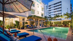 A hotel pool area with lounge chairs, umbrellas, and a building labeled "CIRCA". - Steps to Miami Beach + On-site Dining. Pool. Bikes (Miami Beach)