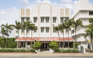 A white building with multiple windows and a red awning with the name "Circa". - Miami Beach Access + On-site Dining. Pool. Bikes. (Miami Beach)