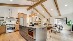 A spacious kitchen with a large island, wooden beams, and modern appliances. - Walk to Gondola: Truckee Retreat w/ Resort Perks! (Truckee)
