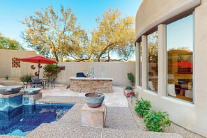 A backyard with a swimming pool, outdoor seating, and a stone fireplace. - Luxury 'grayhawk Getaway' w/ Pool in Scottsdale! (Scottsdale)