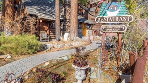A rustic log cabin with a sign for 'The Soul Domain Restaurant' indicating gourmet dining. - Lake Tahoe Adventure Base! Townhome w/ Pool Access (Kings Beach)