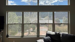 A room with a large window overlooking a landscape with trees and a building. - Dog-friendly Payson Retreat w/ Panoramic Views! (Payson)