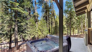 A hot tub on a deck with a forest view. - 4BR Home w/ Spa, Bar, Home Gym, Decks, Near Lake (Arnold)
