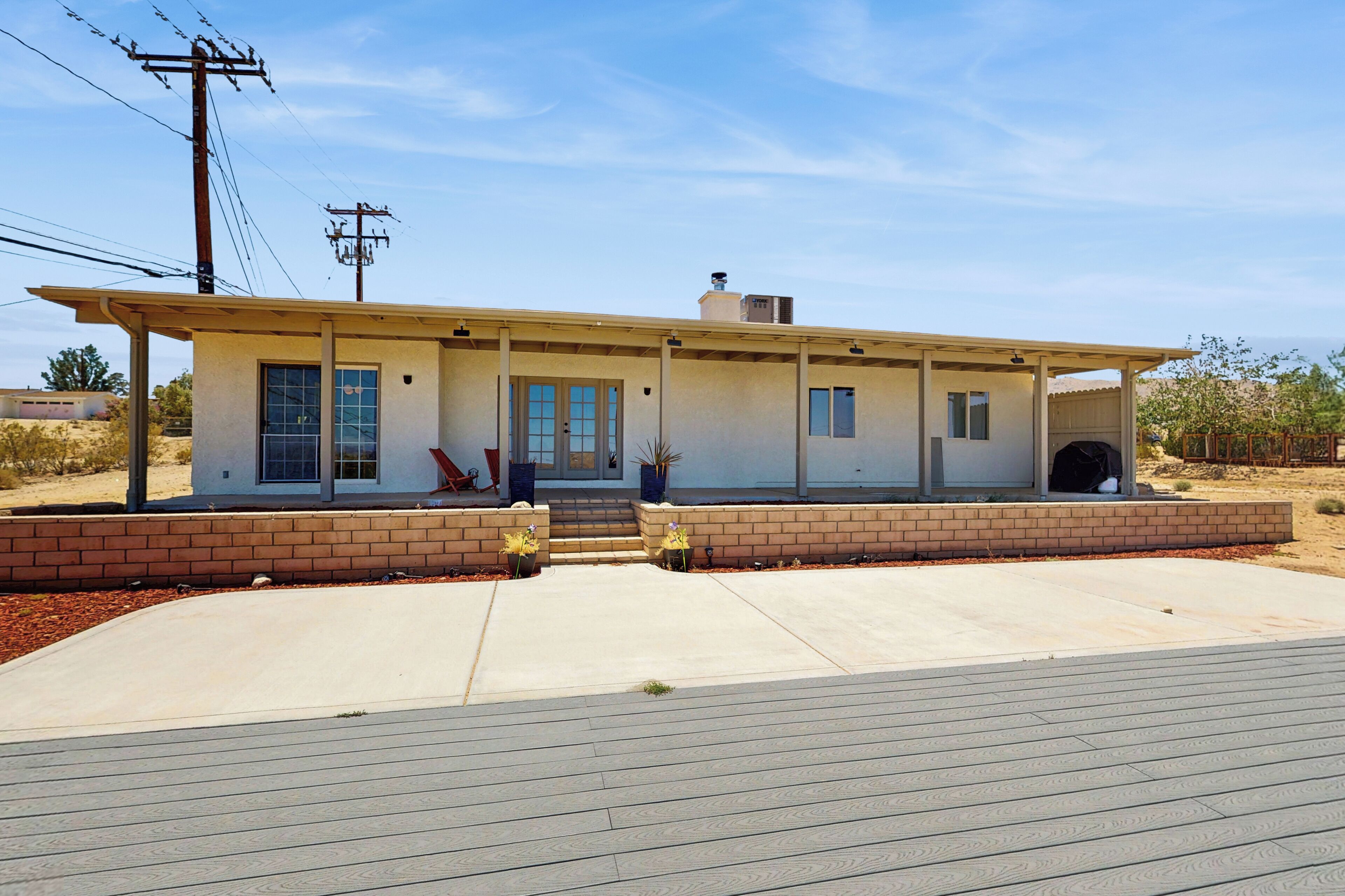 A single-story house with a flat roof, a front porch, and a garage.