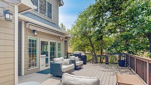 A deck with outdoor furniture, including sofas and a table, and a covered grill area. - Hot Tub & Deck! Outdoor Basecamp in Klamath Falls (Klamath Falls)