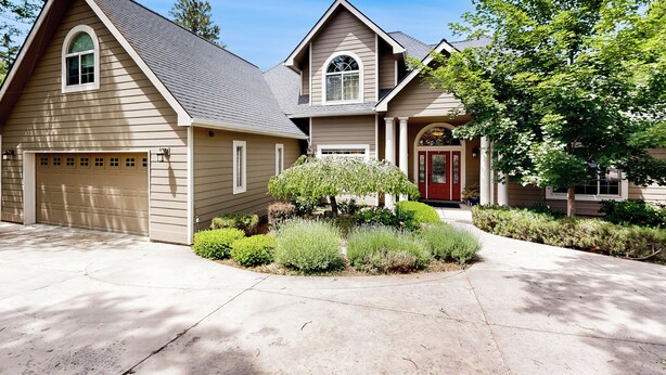 A two-story house with a garage, a front porch, and a well-maintained garden. - Hot Tub & Deck! Outdoor Basecamp in Klamath Falls (Klamath Falls)