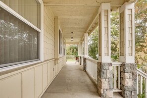 A covered porch with stone pillars, a concrete floor, and a view of trees and a garden in the distance. - Extended Wine Country Stay! Cozy Home in Sonoma (Sonoma)
