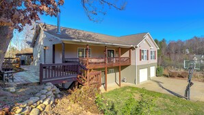 A two-story house with a balcony, a garage, and a basketball hoop. - Covered Deck & Fire Pit: Weaverville Getaway! (Weaverville)