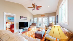 A spacious living room with a ceiling fan, a TV, and a comfortable seating area with a sofa and ottoman. - Boat Dock: Lake-view Retreat 5 Mi to Dtwn Clemson (Seneca)