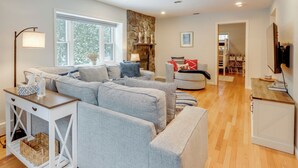 A modern living room with a grey sectional sofa, a white console table, and a wooden floor. - 8 Mi to Dtwn Saratoga Springs: Quiet Family Home (Saratoga Springs)