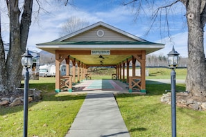 A covered shuffleboard area with a green roof, wooden beams, and a sign. - Near Trails & Slopes! Relaxed Waynesville Retreat (Waynesville)