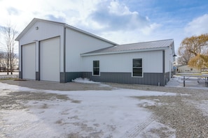A large, single-story industrial building with a metal roof and white walls. - Patio & Parking! Modern Bunkhouse Near Lake Erie (Oak Harbor)