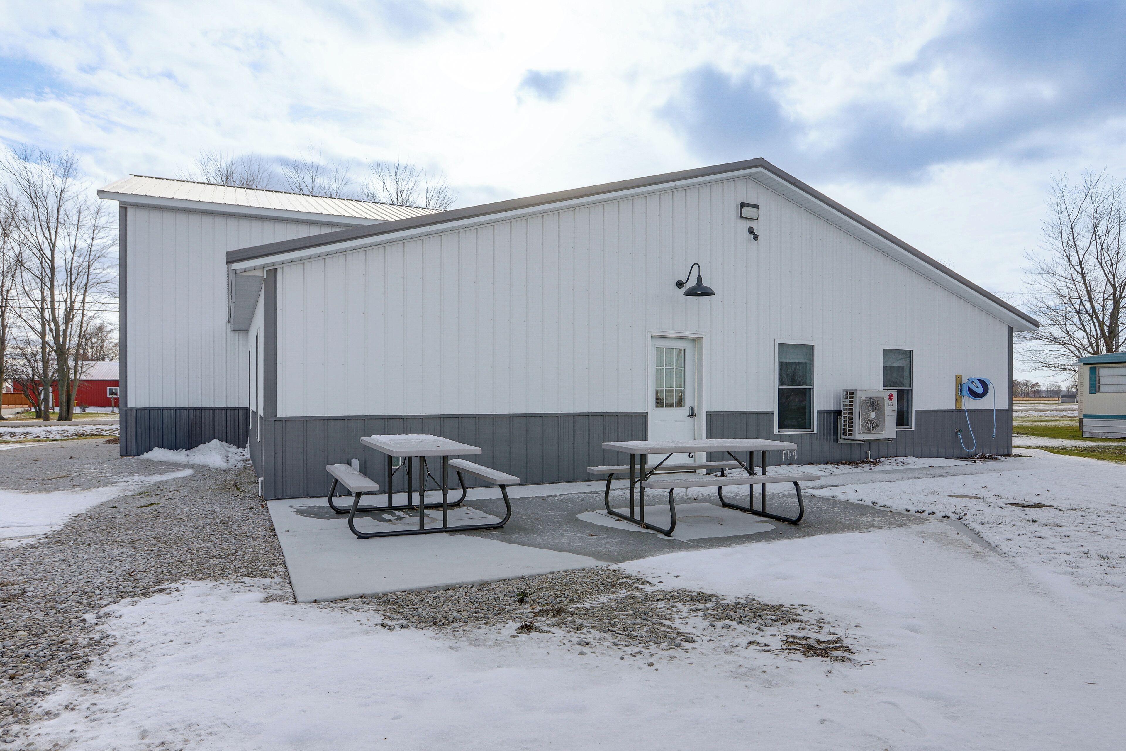 A large industrial building with a flat roof and a door.