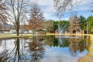 A tranquil outdoor setting with a pond, RVs, and cabins. - Escape to Blue Ridge Mtns! Studio w/ Resort Perks (Waynesville)