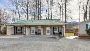 Un bâtiment à deux étages doté d’un toit végétalisé, de nombreuses fenêtres et d’un espace extérieur abrité avec des tables et des chaises.