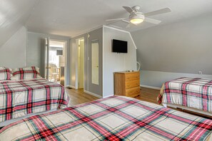 A bedroom with two beds, a ceiling fan, a dresser, and a television on the wall. - Cataloochee Adventure Hub w/ Family-friendly Perks (Waynesville)