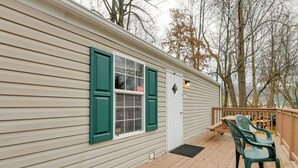 A wooden deck with a door and a window with green shutters. - Mtn-view Deck! Resort Cabin 12 Mi to Waynesville (Waynesville)