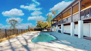 A swimming pool with a wooden deck and a covered patio area. - 3 BR Home: Dog Friendly w/ Scenic Views & Pool (Lookout Mountain)