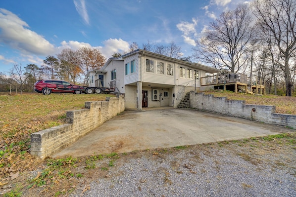 A two-story house with a front porch, a garage, and a deck.