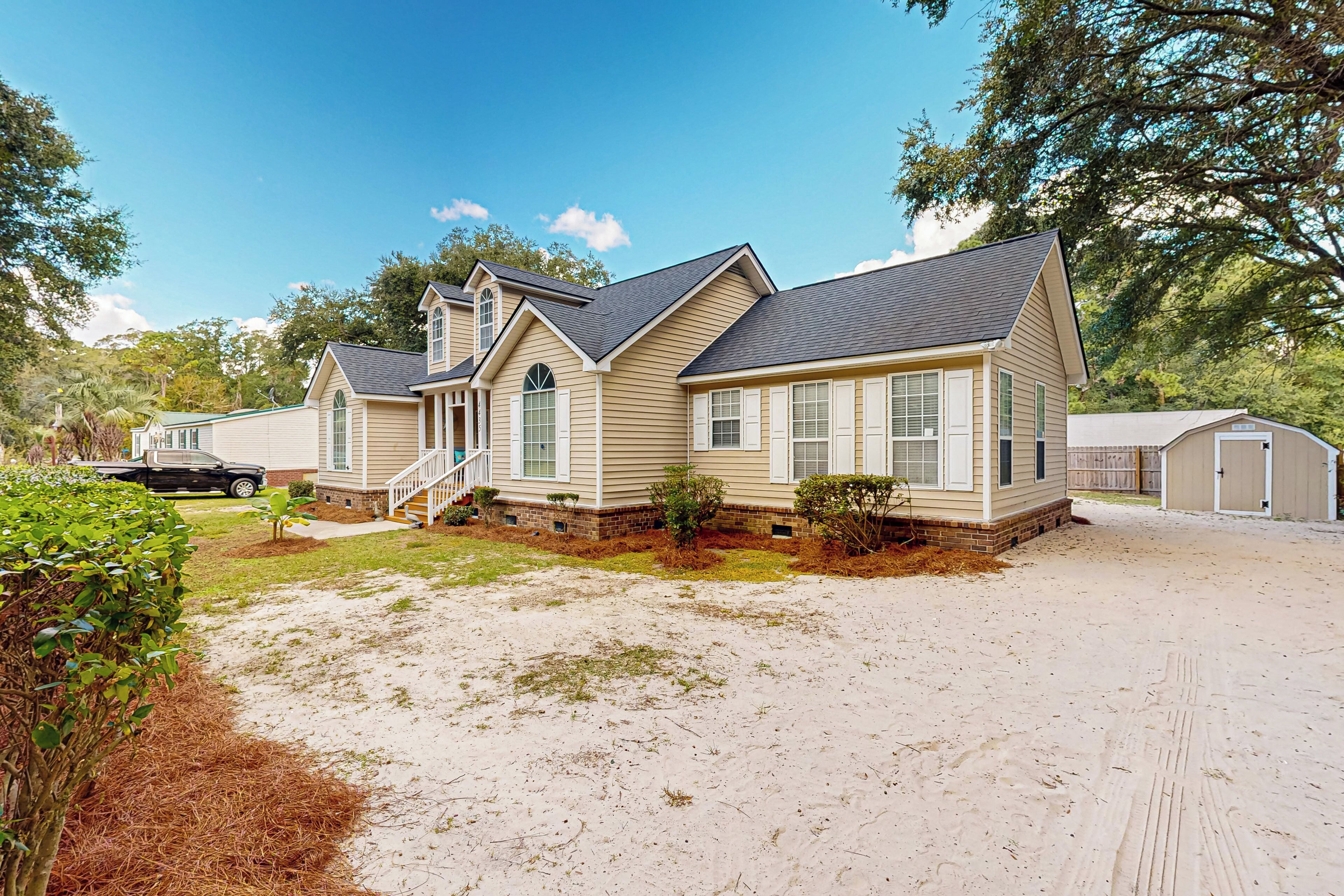 A two-story house with a front porch, a garage, and a covered driveway.