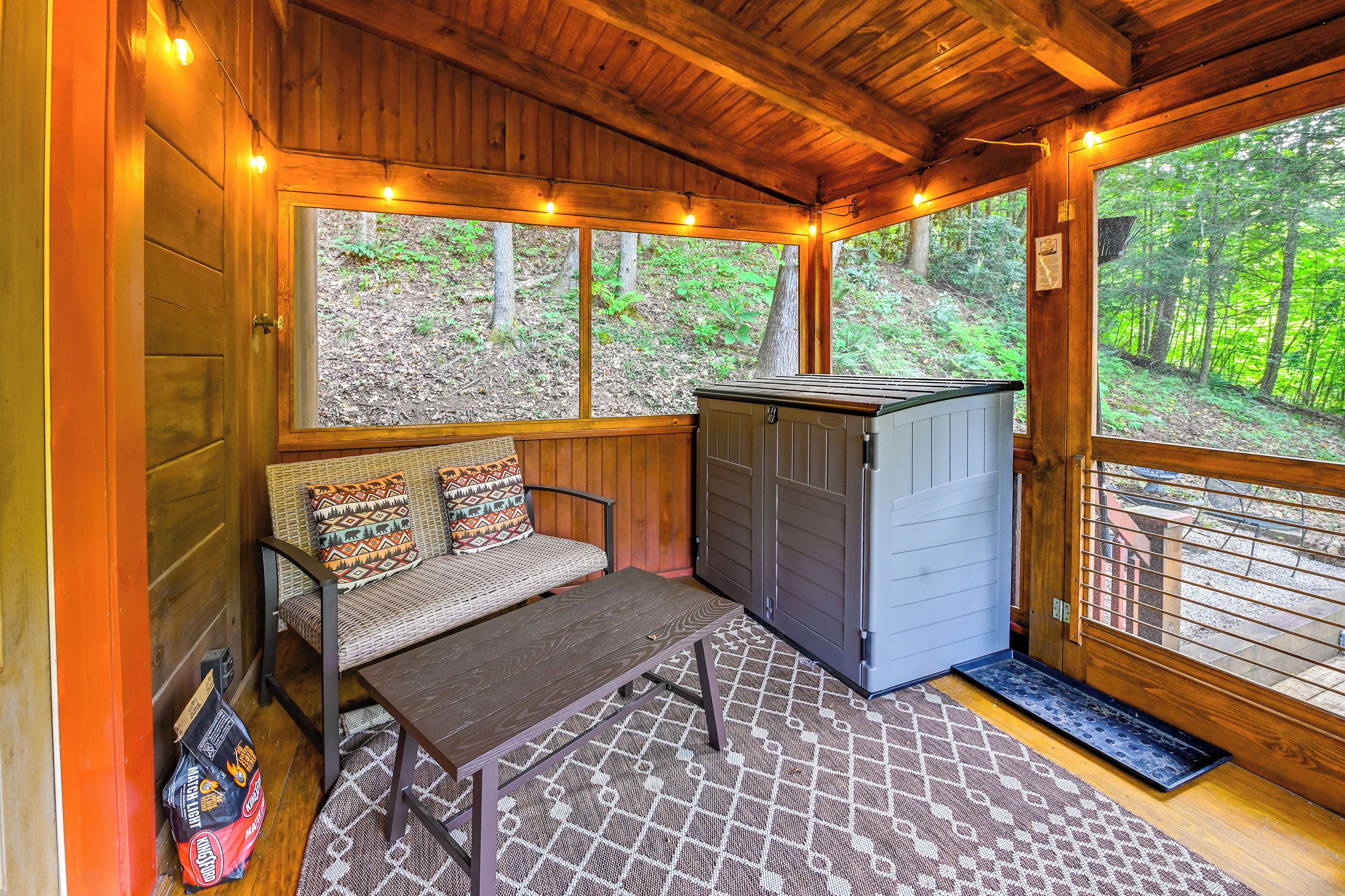 A wooden cabin interior with a bench, a table, and a storage unit.