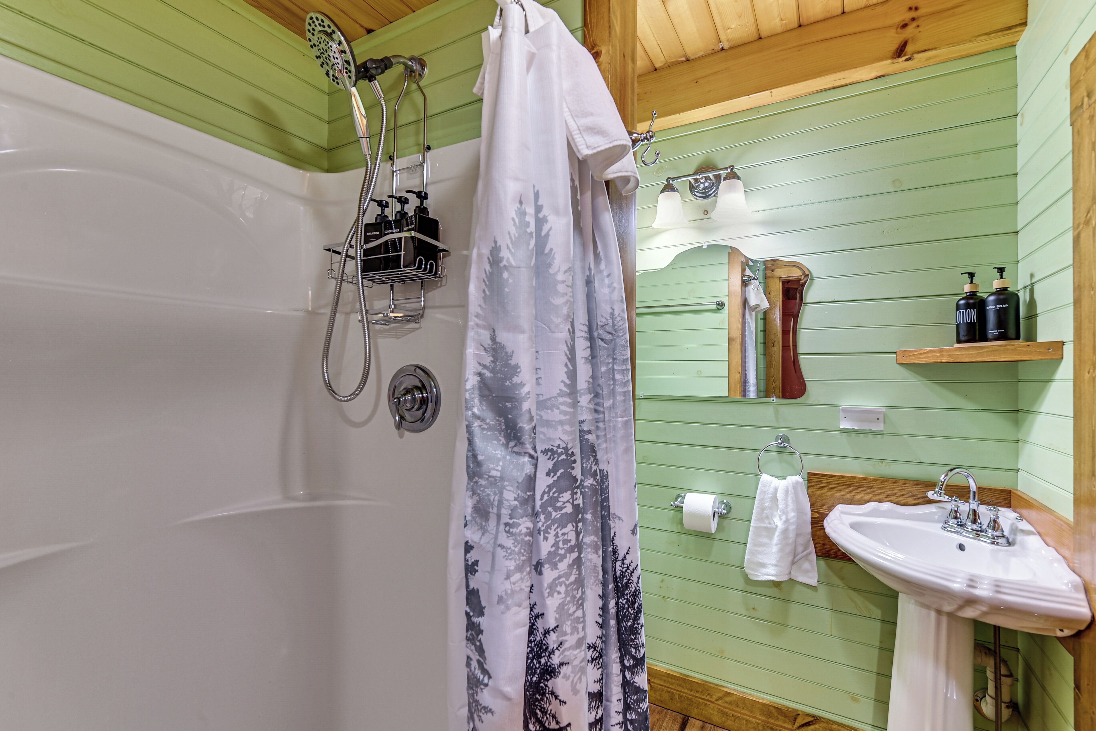 A bathroom with a bathtub, shower, and sink.