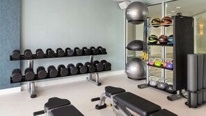A gym with dumbbells, kettlebells, and exercise balls. - Waterfront Elegance Near Cruiseport | Pool & Gym (Fort Lauderdale)