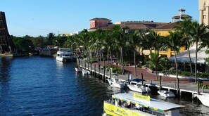 A waterfront area with boats docked along a pier, a water taxi service, and a restaurant with outdoor seating. - Near Airport with Free Shuttle & Pool Vibes (Fort Lauderdale)