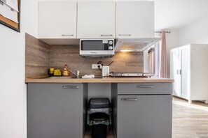 Fridge, microwave, coffee/tea maker, cookware/dishes/utensils