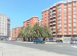 A multi-story building with a modern architectural style, featuring balconies and a brick facade. - Pensión Laurel Self Check-in (Logroño)