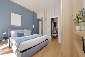 Ein modernes Schlafzimmer mit Bett, Nachttisch und einem Wandbild.
