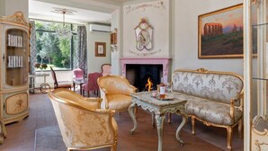 A room with a fireplace, ornate furniture, and a large painting. - Pink Villa - MyHomeinComo (Carate Urio)