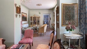 A room with antique furniture, a chandelier, and a large floral painting. - Pink Villa - MyHomeinComo (Carate Urio)